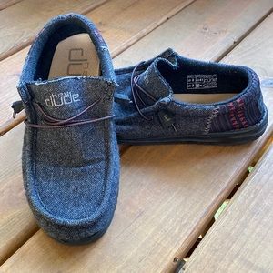 Hey Dude shoes with grey body and red and blue accents